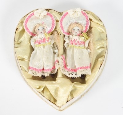 Lot 554 - A pair of bisque twin dolls, original outfits,...