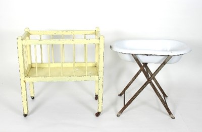 Lot 594 - A dolls wooden cot on brass castors, a white...