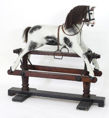 Lot 605 - A rocking horse, dappled grey on a pine stand...