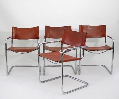 Lot 25 - A set of four chrome tubular chairs with tan...