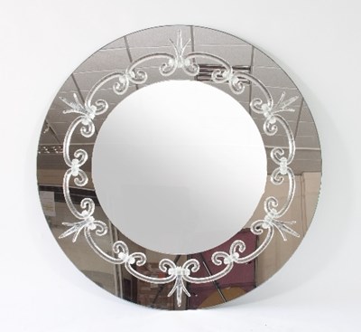 Lot 57 - A large circular mirror, the mirrored surround...