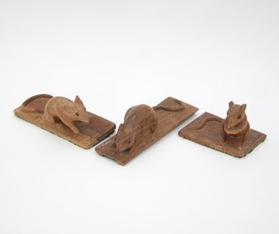 Lot 70 - Three carved oak models of mice, each mounted...