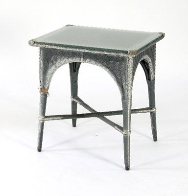 Lot 73 - A Lloyd Loom table with glass top on square...