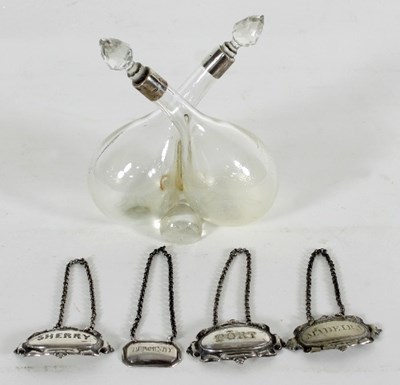 Lot 335 - A silver mounted clear glass bottle set for...