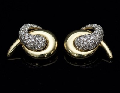 Lot 387 - A pair of diamond ear clips, of interlocking...