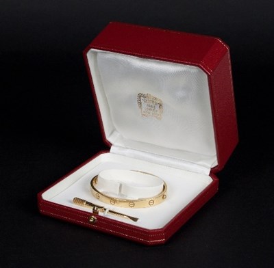 Lot 395 - Cartier: An 18ct yellow gold love bangle,...