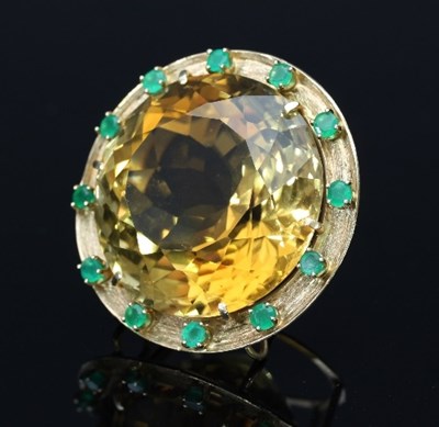 Lot 410 - A citrine and green gem set pendant, the...