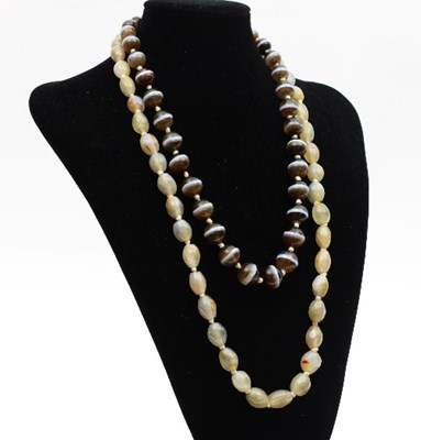 Lot 414 - A banded agate bead necklace, of thirty-four...