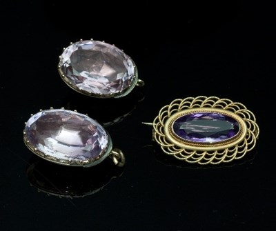 Lot 418 - Two oval amethysts claw set in yellow metal,...