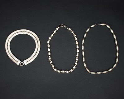 Lot 431 - A group of silver coloured metal necklaces,...