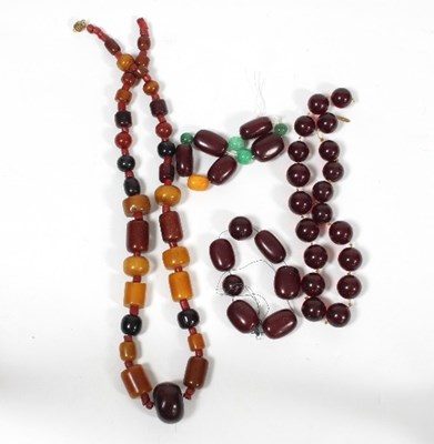 Lot 445 - A coral and faux amber necklace with beads of...