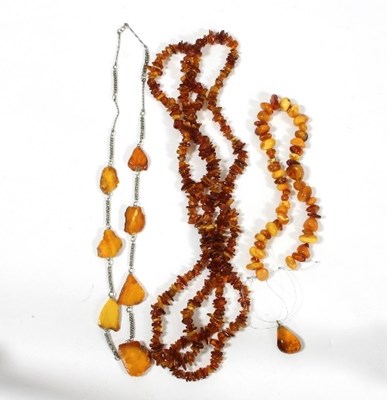 Lot 446 - A long single strand amber chip necklace, a...