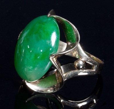 Lot 453 - A jadeite jade set ring, the oval jade...