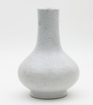 Lot 474 - A Chinese gu type white glazed bottle vase,...