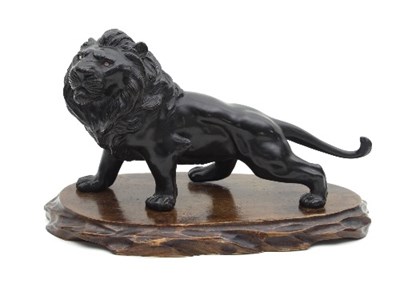 Lot 489 - A Japanese bronze model of a lion, with beaded...