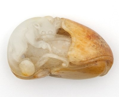 Lot 495 - A Chinese white and russet jade carving of a...