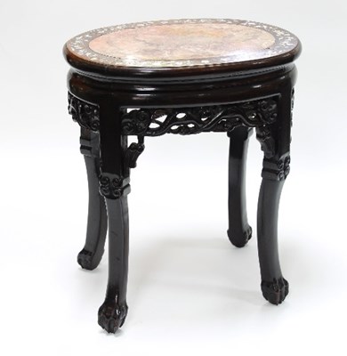 Lot 513 - A Chinese hardwood oval jardiniere stand with...