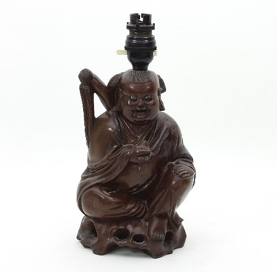 Lot 560 - A Chinese carved hardwood figure of Pu-Tai,...