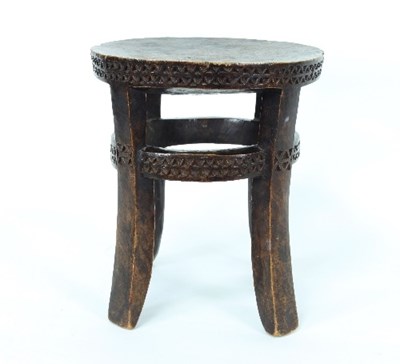 Lot 579 - An African tribal stool, 20th Century, with...