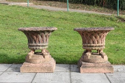 Lot 660 - A pair of terracotta garden urns, the flared...