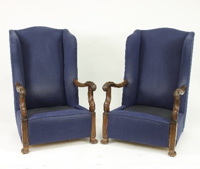 Lot 666 - A pair of upholstered wing back armchairs with...