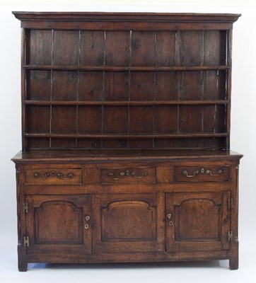 Lot 673 - An 18th Century oak dresser with rack above a...