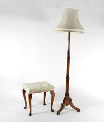 Lot 681 - A walnut standard lamp on turned column with...