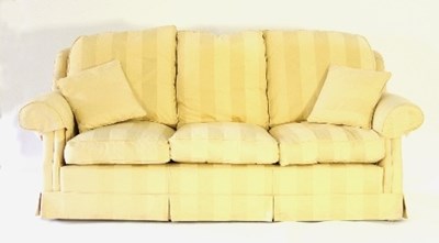 Lot 721 - A pale yellow upholstered three-seater settee,...