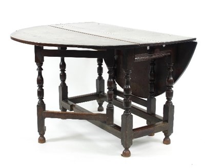 Lot 760 - An 18th Century oak two-flap gate-leg table on...