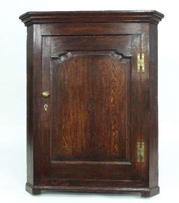 Lot 761 - An early 19th Century oak corner cupboard with...