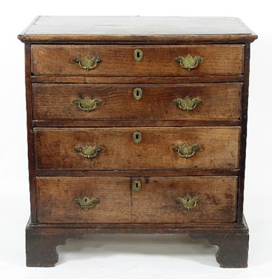 Lot 767 - A George III elm chest of four long drawers on...