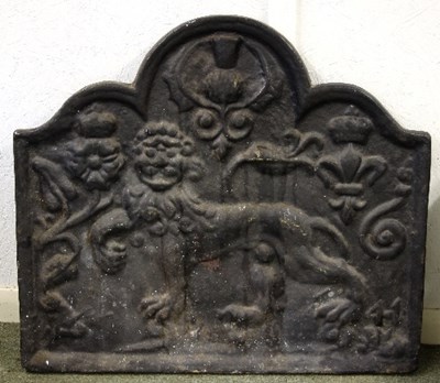 Lot 771 - A cast iron fire back with central lion, rose,...