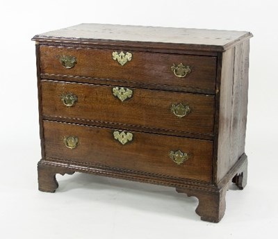 Lot 794 - A George III oak chest of three long drawers...