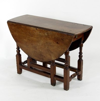 Lot 800 - A early 18th Century walnut oval two-flap gate...