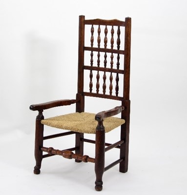 Lot 803 - A spindle back armchair with rush seat, the...