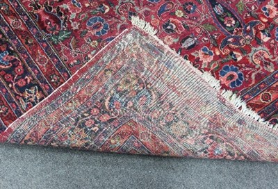 Lot 827 - A Meshed carpet, the madder red ground field...