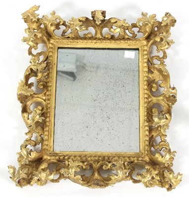 Lot 859 - A Florentine giltwood mirror with elaborate...