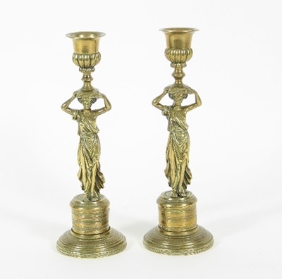 Lot 886 - A pair of Regency brass candlesticks, each...