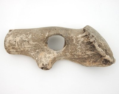 Lot 901 - A bone/antler axe head with central hole for...