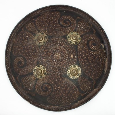 Lot 920 - An Indian hide shield of domed circular form...