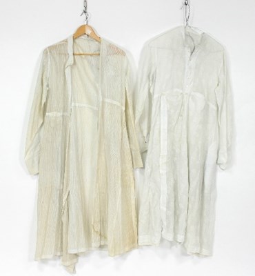 Lot 1003 - An Indian white cotton robe, woven with floral...