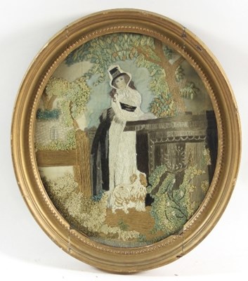 Lot 1024 - A Georgian oval silkwork picture of a woman...