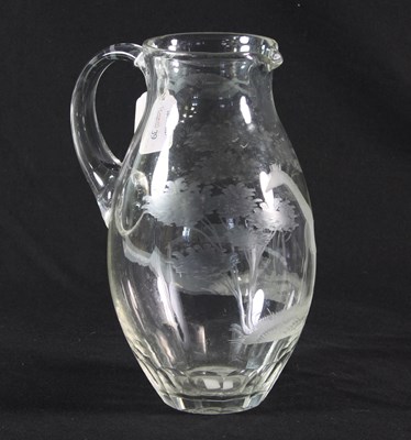 Lot 39 - A glass jug etched with a giraffe amongst...