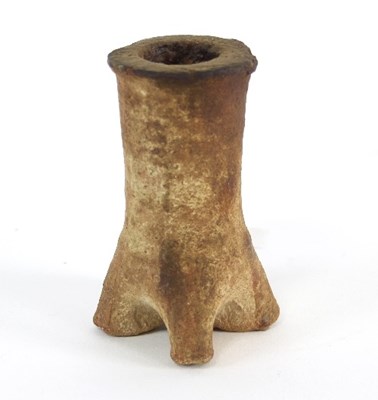 Lot 50 - An early pottery candlestick with pinched base,...