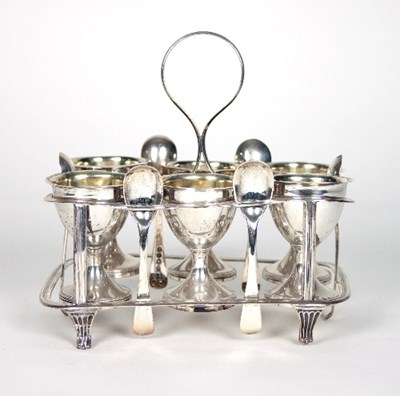 Lot 164 - A George III silver egg cup stand and six egg...