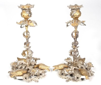 Lot 194 - A pair of silver and silver gilt candlesticks,...