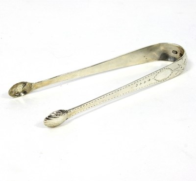 Lot 211 - A pair of Irish silver sugar tongs, JS, Dublin...