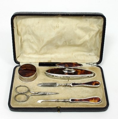 Lot 221 - A tortoiseshell and silver mounted manicure...