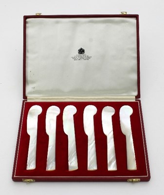 Lot 253 - A set of six mother-of-pearl butter knives in...