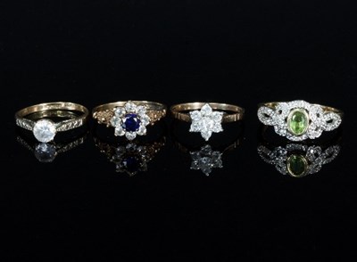 Lot 290 - A peridot and diamond ring and three paste set...